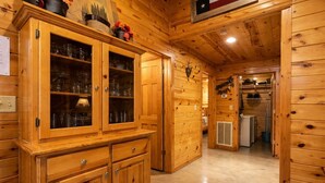 A wooden interior with a cabinet, a heater, and a door leading to another room. - Arrowhead Ridge 3 bedroom 3 bathroom, hot tub, wrap around deck. (Broken Bow)