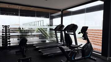 A gym with treadmills, a stationary bike, and weight machines.