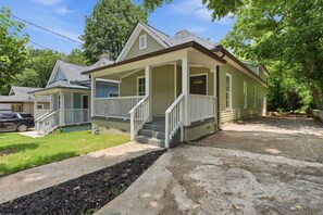 A two-story house with a front porch, a driveway, and a lawn. - Atlanta West End Getaway | Near BeltLine/Downtown (Atlanta)