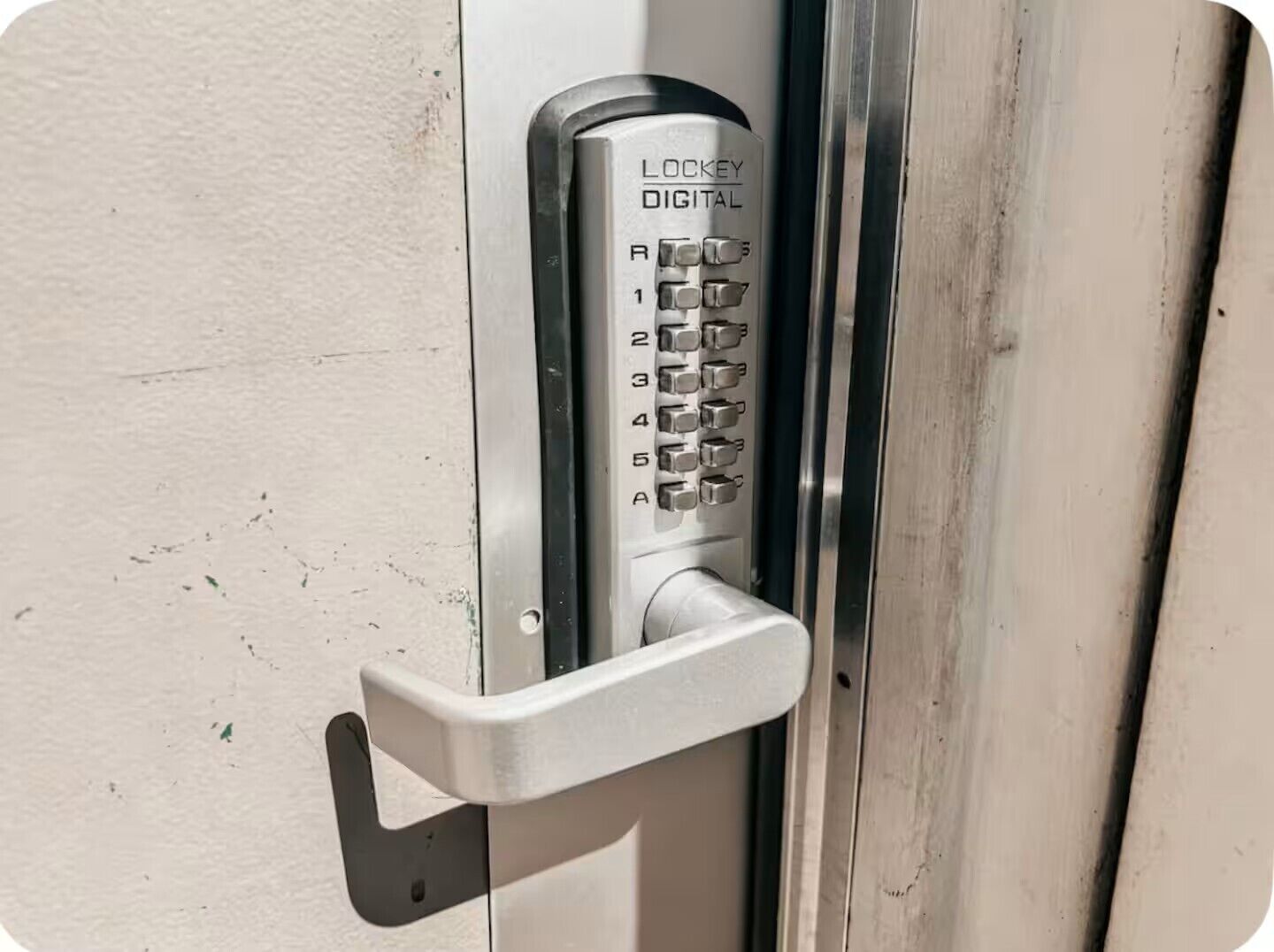 A door lock with a numeric keypad labeled 'LOCKEY DIGITAL' and a keyhole.