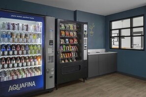A vending machine area with a water dispenser labeled AQUAFINA and a snack vending machine. - StudioRes by Marriott Clearfield Layton (Clearfield)