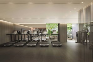 A modern gym with treadmills, stationary bikes, and a weight bench area. - HOTEL THE MITSUI HAKONE, a Luxury Collection Hotel & Spa (Hakone)