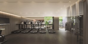 A modern gym with treadmills, exercise equipment, and a TV screen. - HOTEL THE MITSUI HAKONE, a Luxury Collection Hotel & Spa (Hakone)