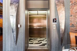 An elevator with a warning sign about using stairways instead of elevators. - Backstage Jam - 2 Units - Walk to Broadway (Nashville)