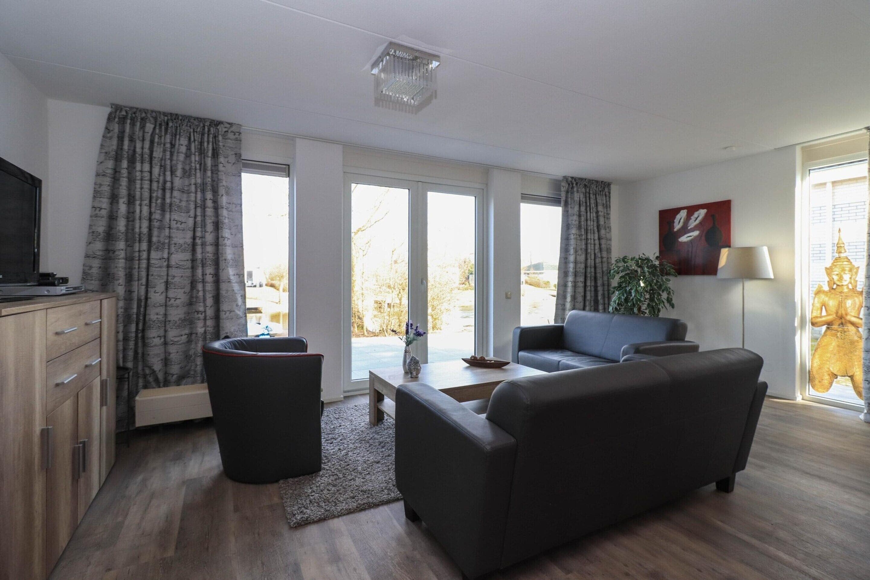 A modern living room with a sofa, a coffee table, and a television.