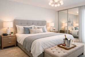 A bedroom with a large bed, bedside tables, a nightstand, a mirror, and a bedside lamp. - Spacious 2BR Apartment in Central Toronto (Toronto)