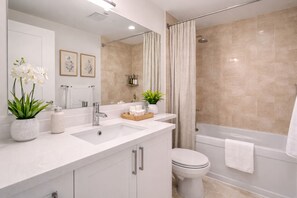 A modern bathroom with a shower, toilet, and sink. - Stylish 2BR Downtown Base for Extended Stays (Toronto)