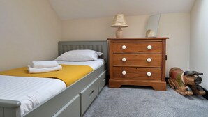 A bedroom with a bed, a dresser, a lamp, and a mirror. - Luxury Lodge With Swim Spa for 8 (Bala)