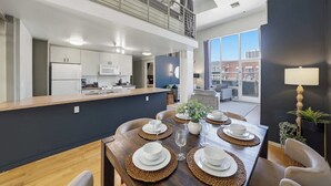 A modern kitchen with white cabinets, a microwave, and a coffee maker. - Explore Gaslamp from Chic Loft +Balcony City Views (San Diego)