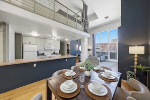 A modern kitchen with white cabinets, a microwave, and a coffee maker. - Explore Gaslamp from Chic Loft +Balcony City Views (San Diego)
