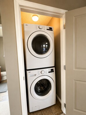 A laundry room with two stacked front-loading washing machines.