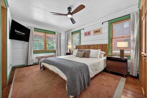 A bedroom with a bed, a nightstand, a TV, and a ceiling fan. - Ski-Out to Hatley Pointe • Alpine Slide • Rec Room (Mars Hill)