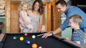 A pool table with balls, a wooden door, and a wall with a sign. - Ski-Out to Hatley Pointe • Alpine Slide • Rec Room (Mars Hill)