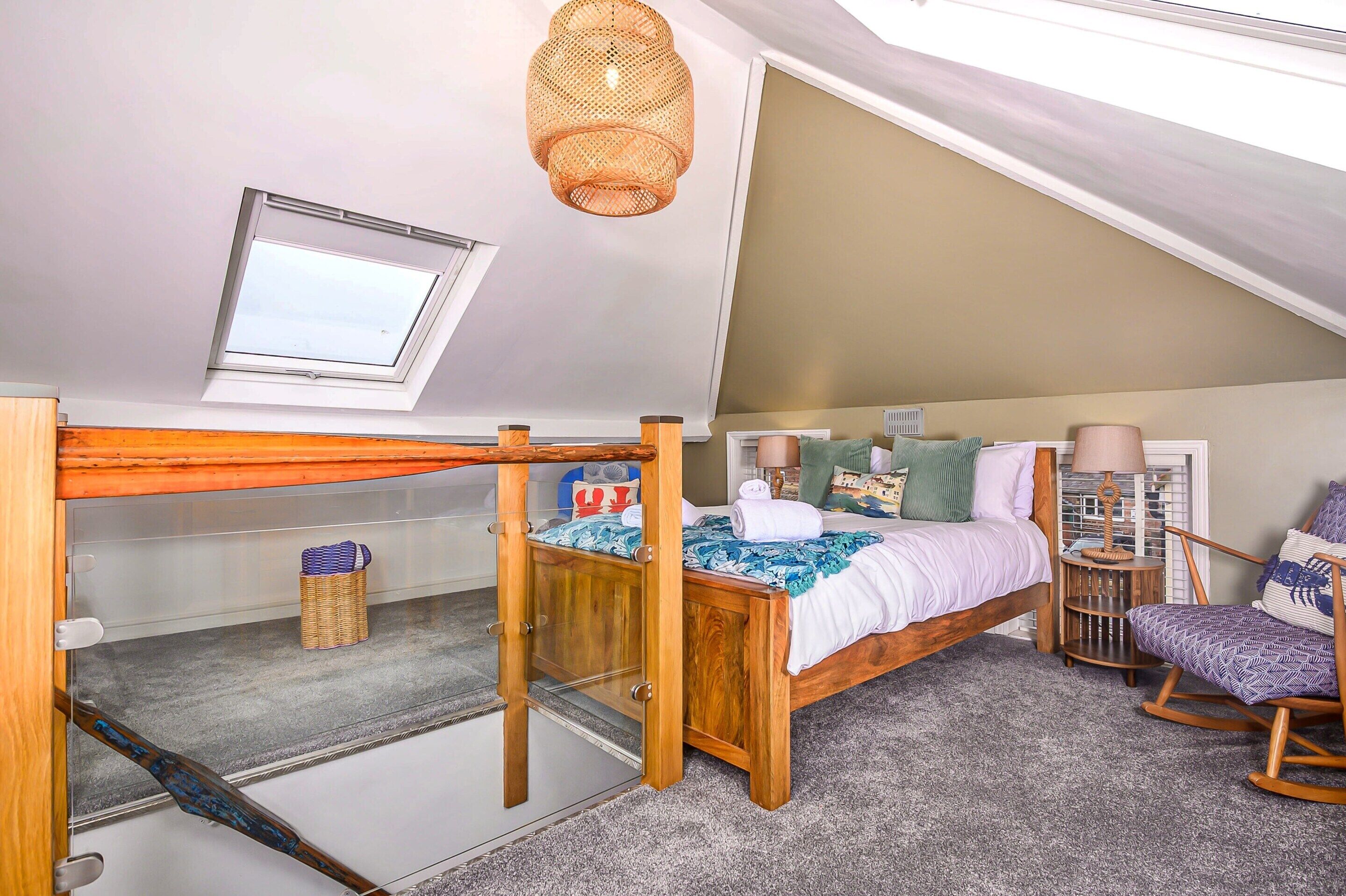 A compact bedroom with a bunk bed, a small window, a ceiling fan, and a view of the sky.