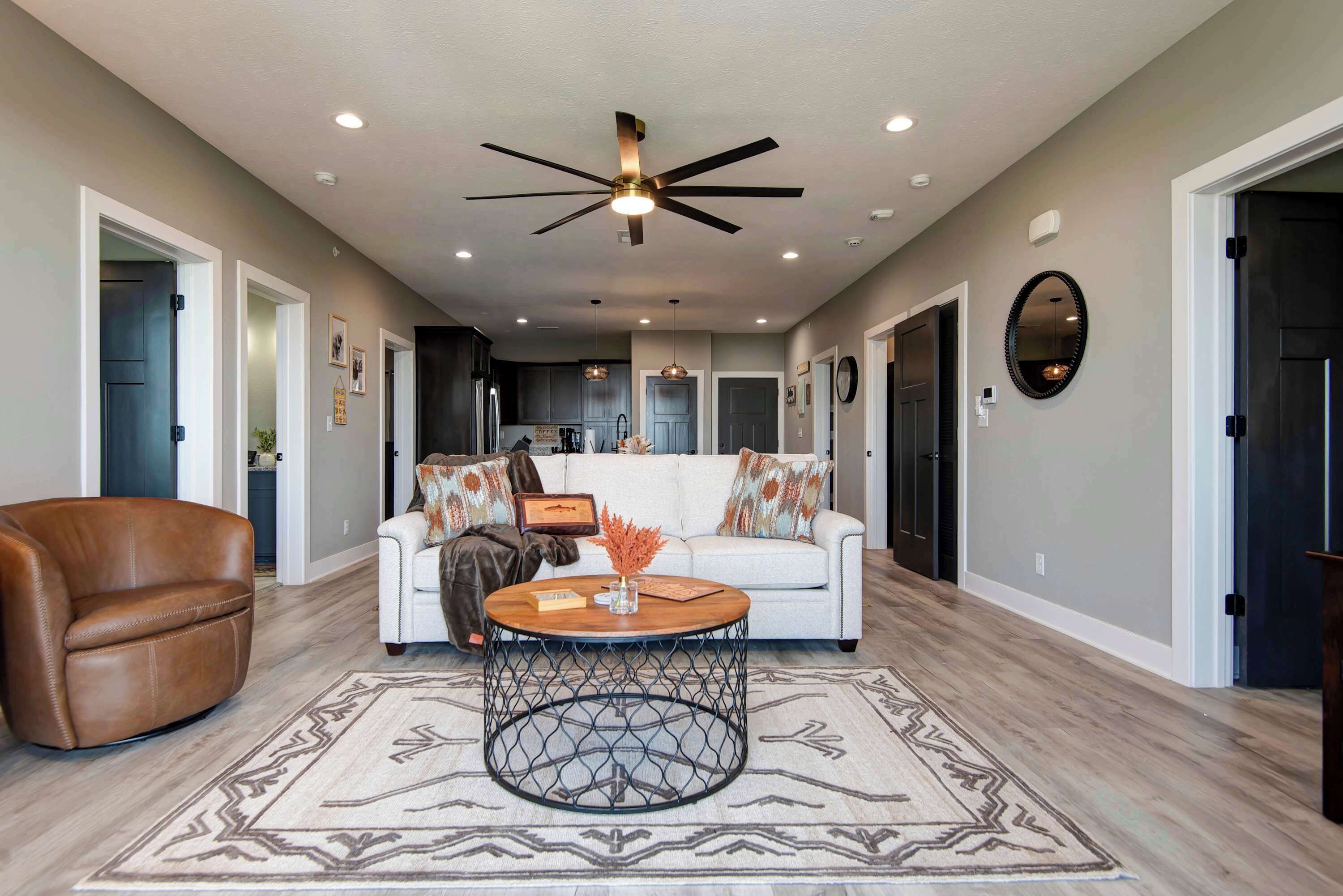 The open-concept living room offers comfortable seating, abundant natural light, and incredible lake views, creating the perfect gathering place for family and friends. The comfortable sleeper sofa provides additional sleeping space,