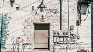 A building facade with a door, a street lamp, and a sign that reads 'the market on MAIN.' - Perfect Downtown Location in Mount Pleasant with AC (Mount Pleasant)