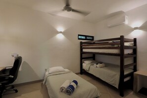A small, compact room with bunk beds, a desk, and a chair. - Beautiful home in La Punta with a private pool, rooftop terrace, and AC. (Puerto Escondido)