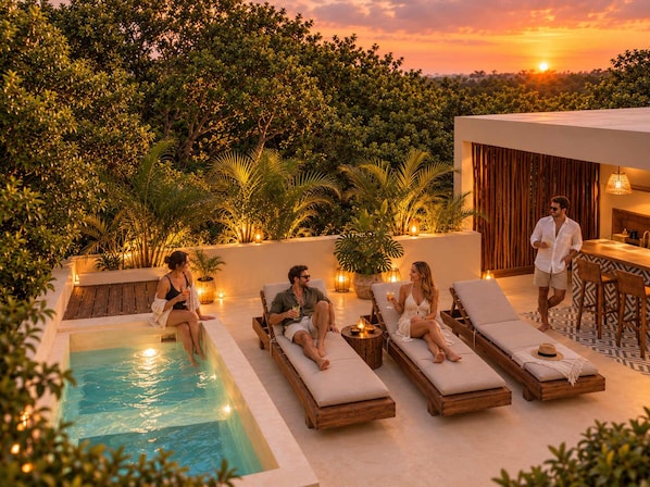 A poolside area with lounge chairs and a pool, surrounded by greenery and a sunset view. - Remodeled 4BR Boho Villa · Pool Trilogy + Hot Tub (Tulum)