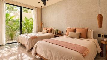 A hotel room with two beds, a ceiling fan, a large window with curtains, and a view of greenery outside.