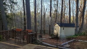 A wooden deck with chairs, a small shed, and a fenced garden area. - 3-bedroom house in Durham near UNC, Duke and the American Tobacco Trail (Durham)