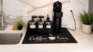 A kitchen with a coffee machine, a sink, and a dishwasher. - Modern Luxury-Lower Greenville (Dallas)