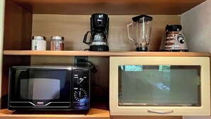A kitchenette with a microwave, coffee maker, blender, and a small refrigerator. - Hogar en Altamira Acogedor y en el Corazón de Todo (Caracas)