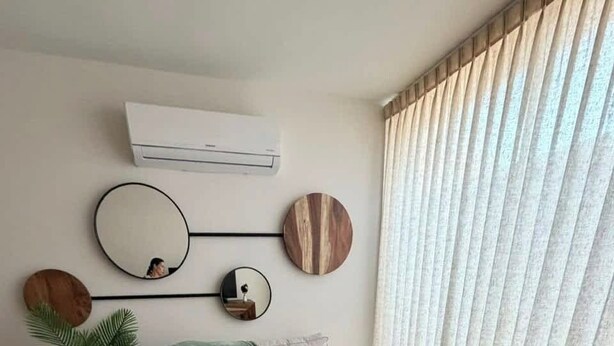 A modern living room with a sofa, a coffee table, and decorative wall art. - Temozón Norte | Alberca, Jacuzzi y Gym (Merida)