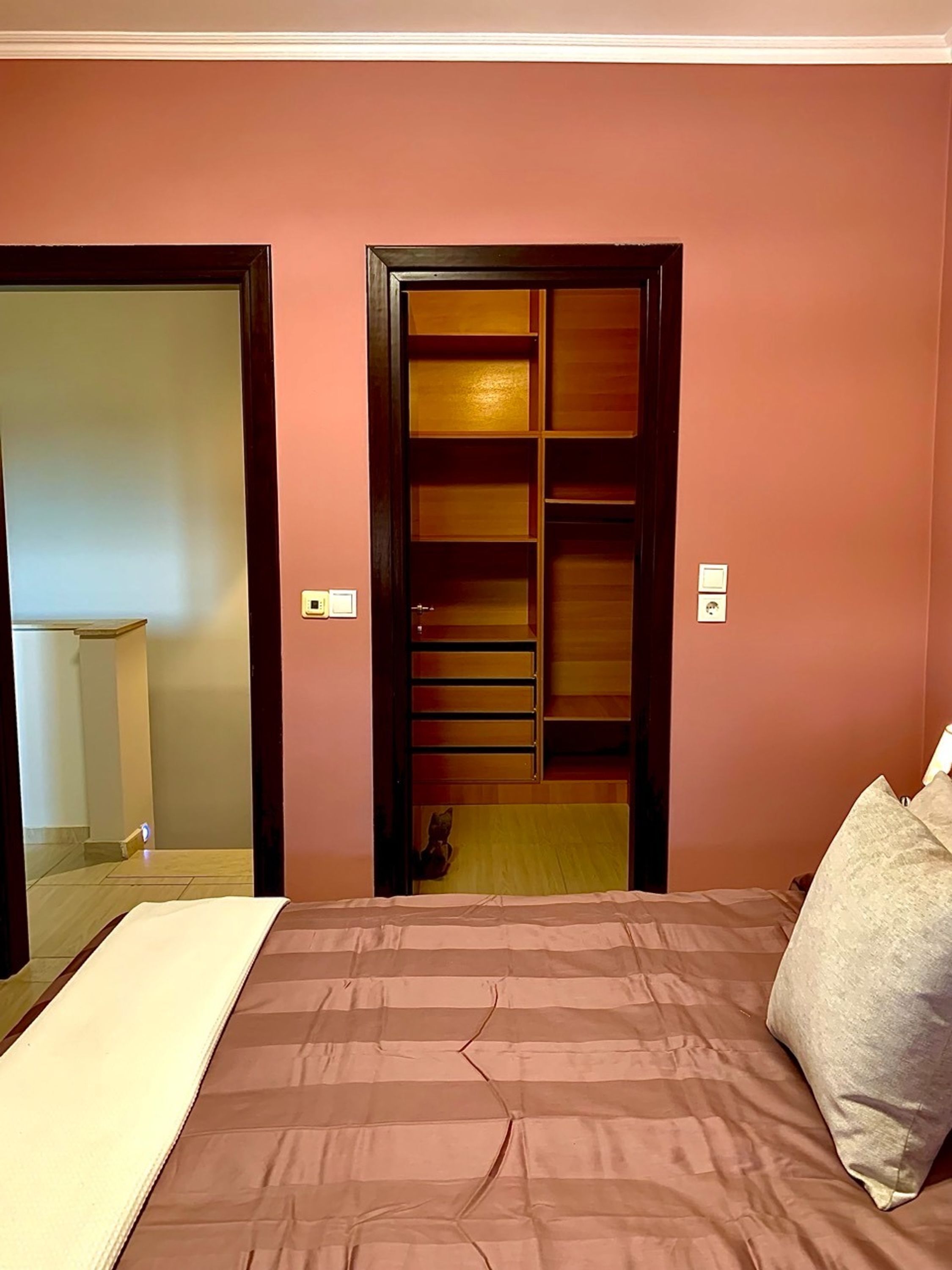 Une chambre à coucher avec un lit, une armoire et un miroir.