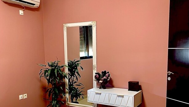 Une chambre à coucher comprenant un lit, une commode, un miroir et un appareil de climatisation.