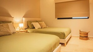 A bedroom with two beds, a bedside table with a lamp, a window with blinds, and a woven basket on the floor. - Dpto. de 2 Hab. Frente a la Playa & Amenidades Top (Progreso)