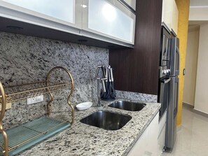 A kitchen with granite countertops, stainless steel appliances, and a double sink. - Vista al Mar - Bahia de Bella Vista (Porlamar)