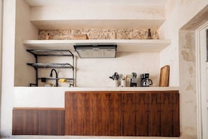 A kitchen with a built-in stove, a sink, and wooden cabinets. - Colonial Mérida Retreat w/ Private Pool & Parking (Merida)