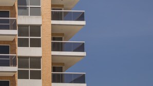 A multi-story building with balconies and windows.