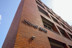 A building with the sign 'NOMAD SUITES' indicating a hotel or accommodation.
