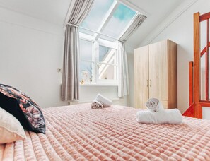 A bedroom with a bed, a window with curtains, a wardrobe, and a radiator. - Deluxe Dike Villa With Sauna for 6 (Makkum)