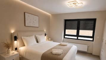A bedroom with a bed, bedside tables, a window with blinds, a radiator, and a wall-mounted light fixture.