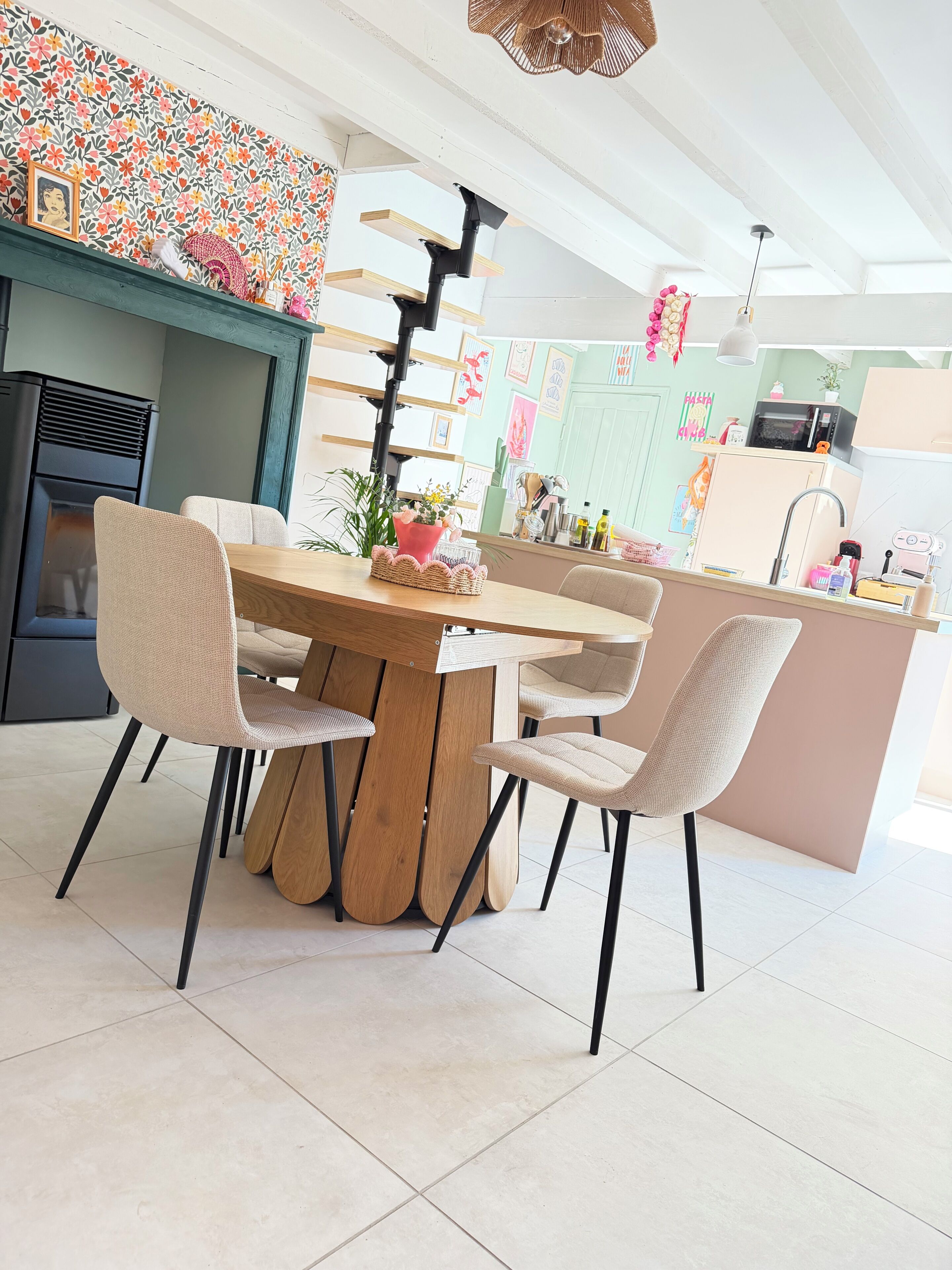 A modern kitchen with a central island, a dining table with chairs, and a built-in stove.