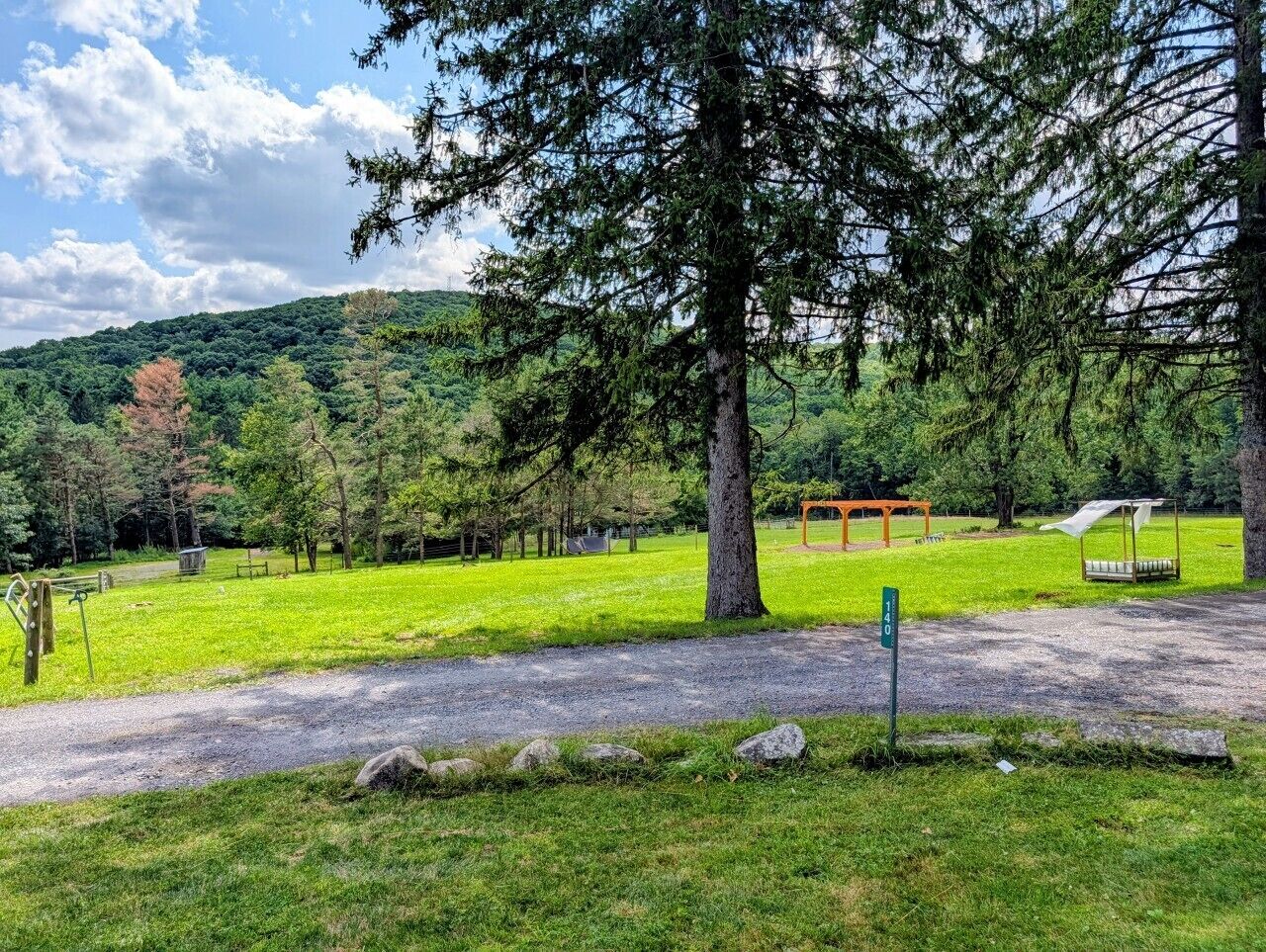 A park with a paved path, a gazebo, and a playground.