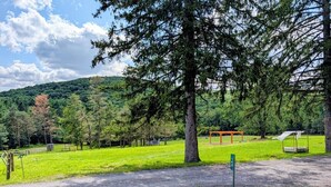 A park with a paved path, a gazebo, and a playground. - The Stone House | Boutique Farm * Highland Cow * Baby Goats * Bunnies (Cresco)