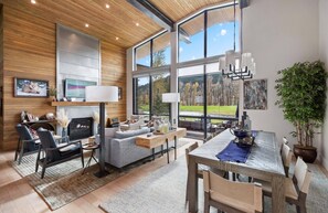 Living area with art on the walls, abundant natural light, and views across the fairway to the mountains - Elegant 2BR Cabin w/ Golf Views + Hot Tub & BBQ (Jackson)