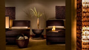 A room with two armchairs, a small table with candles, a woven basket, and a tall vase with a plant. - Ski-In Condo | Tram-Adjacent | Mountain Views (Jackson Hole)