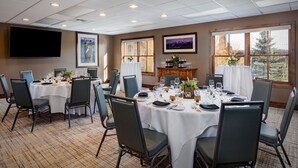A conference room with multiple tables set for dining, equipped with chairs and a television on the wall. - Grand Alpine Lodge w/ Sauna, Hot Tub & Game Room (Jackson Hole)