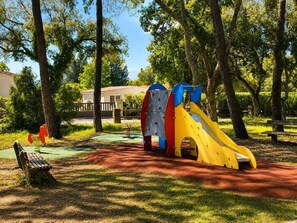 A playground with a slide and climbing structures in a park. - Villa with pool & pool house – AC – 6/8 guests (Roquebrune-sur-Argens)