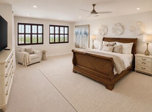 A bedroom with a large bed, a dresser, a nightstand, a TV, and two windows. -     BleuSalt No. 16 Luxury Beach Retreat in The  Villages of Tannin (Orange Beach)