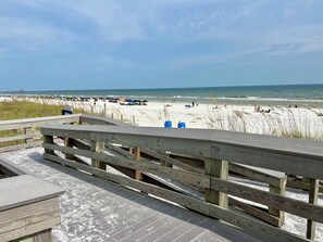 A wooden boardwalk leading to a beach with sand dunes and a clear sky. - 3-Min Walk to Beach! King + 2 Queens, 2.5 Baths • Sleeps 6 (Fort Walton Beach)