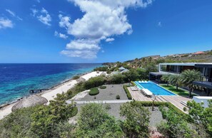 A resort with a pool, beach, and ocean view. - Villa Coral Breeze | Luxury Villa | Private Beach (Willemstad)