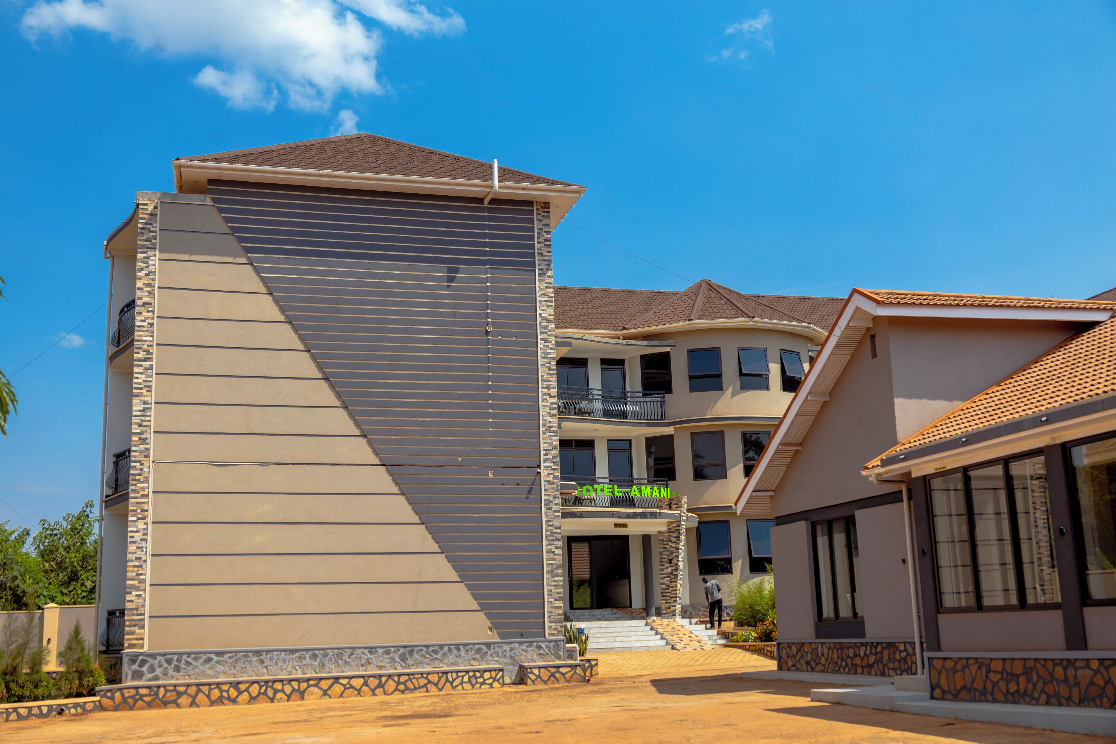 A multi-story hotel with a modern design, featuring a prominent vertical structure and a covered entrance.