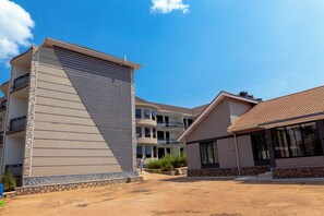 A multi-story residential building with a flat roof and a balcony.