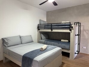 A room with a bunk bed, a single bed, and a ceiling fan. - Vive la Zona Dorada, Boca de Mar by Partner Host (Mazatlán)