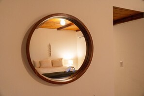 A round mirror with a wooden frame on a wall. - Bed N` Burke | Pool + Spa | Peloton | Fire Pit (Yucca Valley)